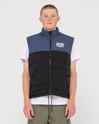 Man wearing One Hit Puffer Vest in Navy / Washed Black