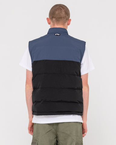 Man wearing One Hit Puffer Vest in Navy / Washed Black