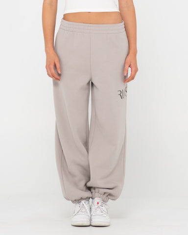Woman wearing Rusty Signature Oversize Trackpant in Grey Cloud