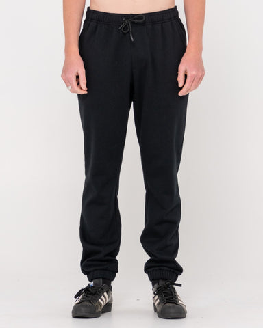 Man wearing One Hit Wonder Trackpant in Black/musk Melon