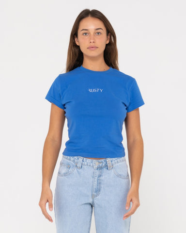 Woman wearing Rusty Signature Skimmer Baby Tee in Blue Sapphire